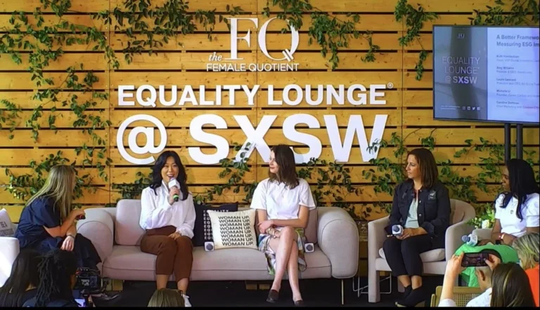 Four women sit on a stage at a bright, modern event, talking and holding microphones. The wooden wall with green vines and “EQUALITY LOUNGE @ SXSW” sign highlights expert event planning and conference planning services in action.